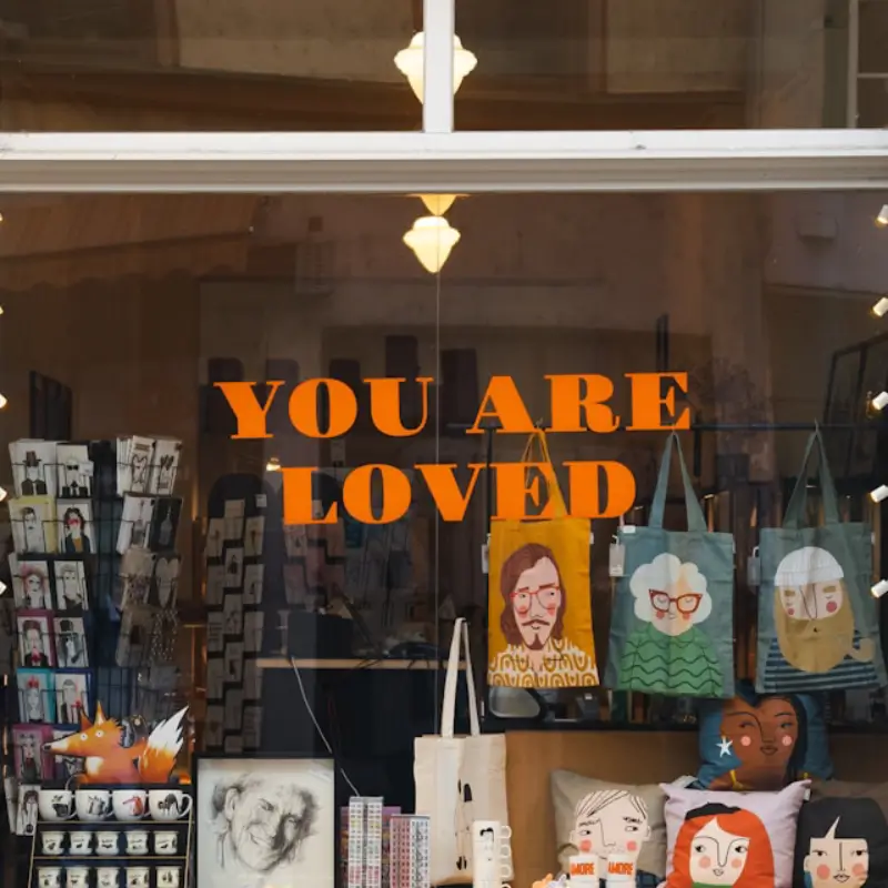a store window displaying 'you are loved'